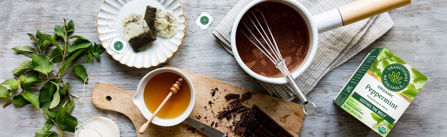 Peppermint Tea box overhead shot with chocolate, honey, and cooking utensils