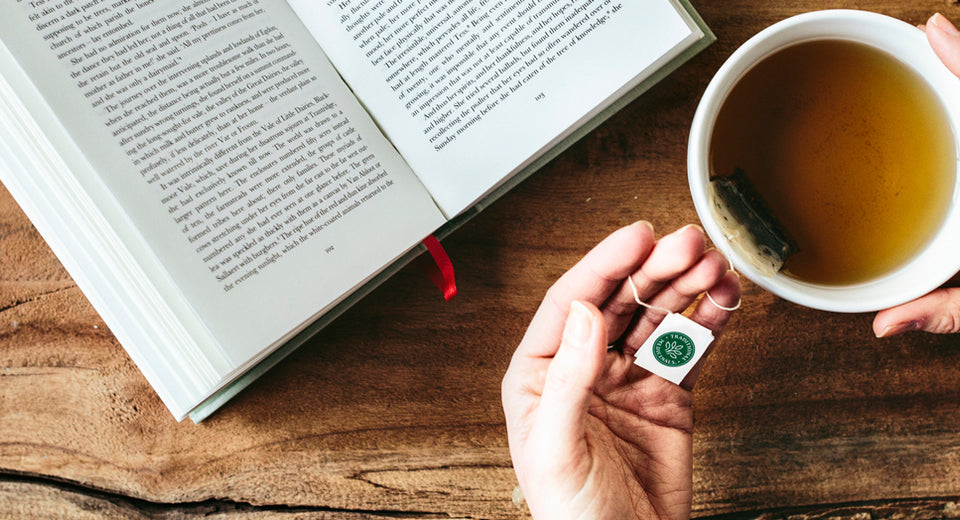 Person enjoying tea while reading